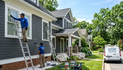Professional house painters working on residential exterior in Raleigh NC