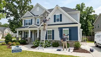 Professional house painters finishing exterior home in Raleigh, NC