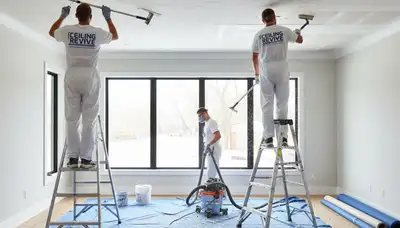 Technician performing popcorn ceiling removal in Raleigh NC home during professional refinishing service